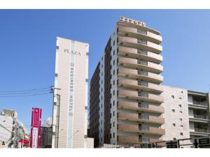 a tall building next to two tall buildings at Kagoshima Plaza Hotel Tenmonkan - Vacation STAY 97872 in Kagoshima