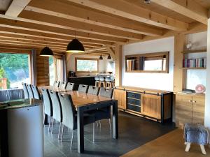 a dining room with a wooden table and chairs at Chalet Soleya in Le Grand-Bornand