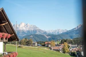 a view of a town with mountains in the background at Apparthotel Feldhof - Living and Bistro in Nova Ponente