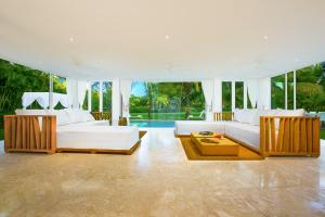 a large living room with two white couches and a table at Luxury Villa Waterfall with Private Pool, BBQ & Maid in Punta Cana