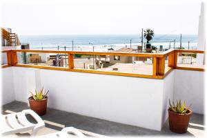 a balcony with a view of the beach at ATMA Hostel & Yoga in Huanchaco