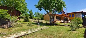 a house with a stone path next to a building at DIMITRA's VILLAS in Elatochori