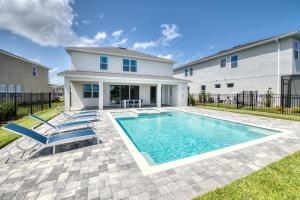 a swimming pool in front of a house at Gleaming Home by Rentyl with Theater Room near Disney - 209S in Orlando