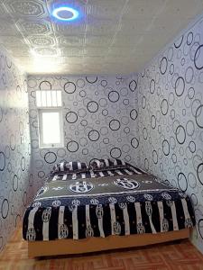 a bedroom with a bed in a room with a ceiling at Ustin Nagoya Bukit Lawang Orangutan Trekking & transport You can only stay at the hotel if you book your trekking with us in Bukit Lawang