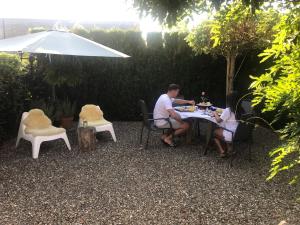 a man and a woman sitting at a table at Belle Chique - Maastricht in Lanaken
