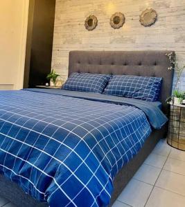 a blue comforter on a bed in a bedroom at Casa De Roanne in Tagaytay
