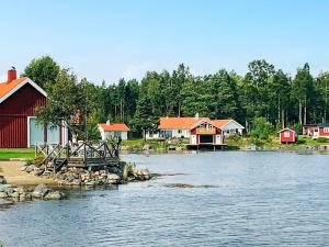 a group of houses on the shore of a lake at 4 person holiday home in NORRSUNDET in Norrsundet