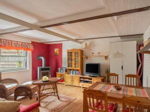 a living room with a table and a television at Quaint Holiday Home near Forest in Stuer in Stuer