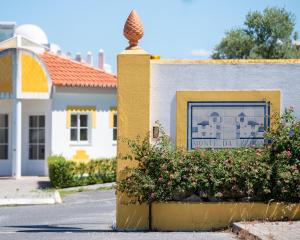 a building with a sign for a home department at Hotel Rural Monte da Leziria in Santo André