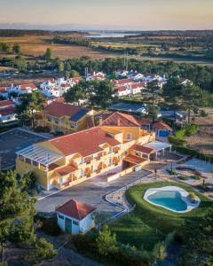 an aerial view of a house with a swimming pool at Hotel Rural Monte da Leziria in Santo André