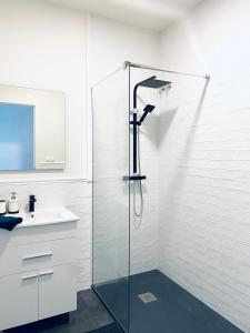 a glass shower in a bathroom with a sink at GMC Turistics - La Casa de los Álamos in Málaga