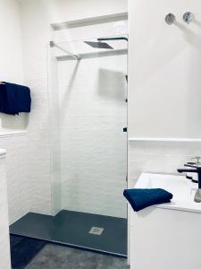 a shower with a glass door in a bathroom at La Casa de los Álamos in Málaga