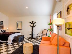 a bedroom with a bed and a couch at Mirriyindi for 7 Berrima in Berrima