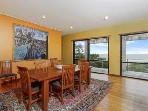 a dining room with a wooden table and chairs at Number Nine Gerroa in Gerroa