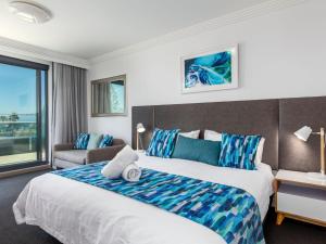a hotel room with a bed and a couch at Sebel Harbourside 301 Kiama in Kiama