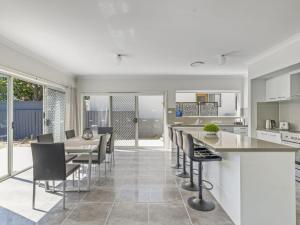 a kitchen and dining room with a table and chairs at Sea Mist Gerringong in Gerringong