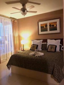 a bedroom with a large bed with a ceiling fan at HOTEL PLAZA RIVIERA in Matamoros