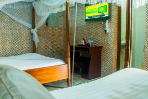 Voodi või voodid majutusasutuse Sandton Hotel Kasese toas