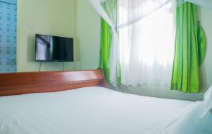 Voodi või voodid majutusasutuse Sandton Hotel Kasese toas