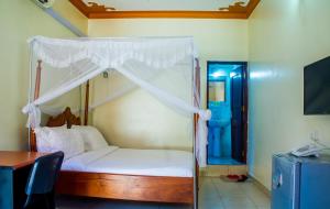 Voodi või voodid majutusasutuse Sandton Hotel Kasese toas