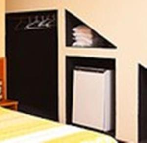 a room with two refridgerators and a bed at Caparaó Parque Hotel in Caparaó Velho