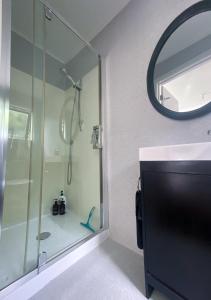 a bathroom with a shower and a mirror at Delightful Lake Hawea Cabin with Mountain Views in Lake Hawea