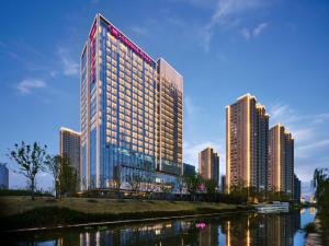 a tall building with many windows in a city at Crowne Plaza Qidong, an IHG Hotel in Qidong