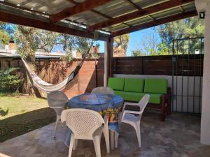 a patio with a table and chairs and a hammock at ELIMAR in Playa Verde