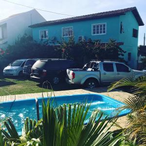 a group of cars parked in front of a house at Residencial Segundo Piso in Garopaba