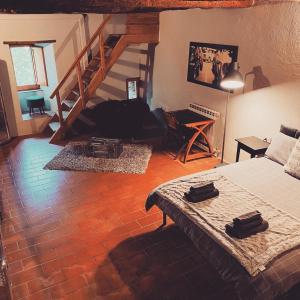 sala de estar con cama y escalera en Mirabella - Monte Petriolo, en Monte Petriolo
