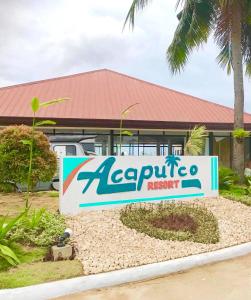 a sign for an expedia resort in front of a building at Acapulco Resort in Toledo City