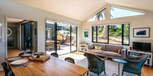 a living room with a table and a couch at Art Lovers Retreat in Onetangi