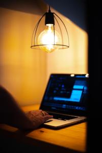 a laptop computer sitting on a desk next to a lamp at Cabañas del Cerro in Valle Grande