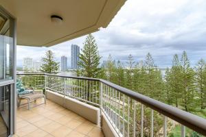 a balcony with a view of trees and buildings at Main Beach Waterfront Apartment in Gold Coast