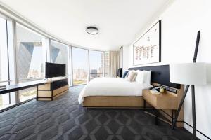 a hotel room with a bed and a tv at JEN Beijing by Shangri-La in Beijing