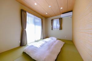 Postel nebo postele na pokoji v ubytování 05 Resort Club -然ZEN-