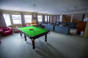a living room with a pool table in it at Lucy Lodge in Charlotte Pass