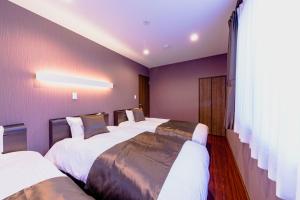 Postel nebo postele na pokoji v ubytování 06 Resort Club -粋IKI-