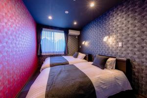 Postel nebo postele na pokoji v ubytování 06 Resort Club -粋IKI-