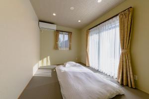 Postel nebo postele na pokoji v ubytování 06 Resort Club -粋IKI-