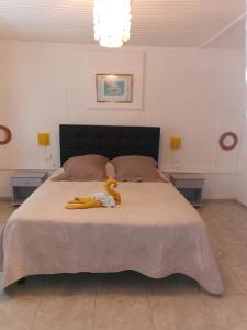 a bedroom with a large bed with two night stands at Les GREVILLEAS in La Plaine des Cafres