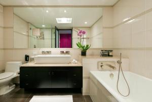 a bathroom with a sink, toilet, and bathtub at Royalton Park Avenue in New York