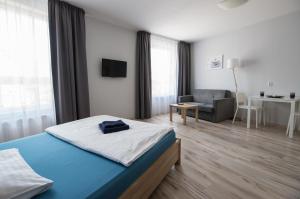 a bedroom with a bed and a chair and a desk at Parkowa 13 in Szczecin