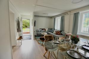 a living room with a glass table and a couch at ALP APARTMENTS centre location with traditional design and self check-in in Engelberg