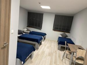 A bed or beds in a room at Noclegi Europol