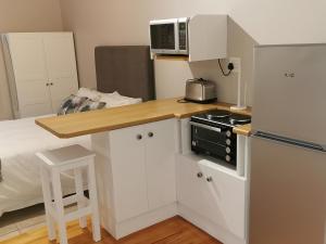 a small kitchen with a counter top and a microwave at 65at3rd in Newton Park