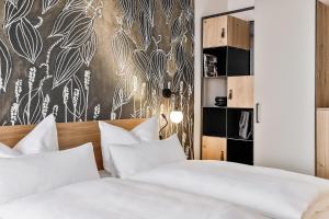 Postel nebo postele na pokoji v ubytování WeinHotel Fritz Walter