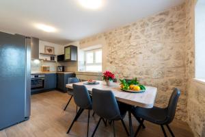 a kitchen and dining room with a table and chairs at Villa Ane in Čelopeci