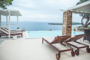 a patio with a view of the ocean at Nissi View Villa in Vourvourou