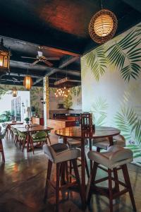 a restaurant with wooden tables and chairs and plants on the wall at Nazeki Villa in Uluwatu